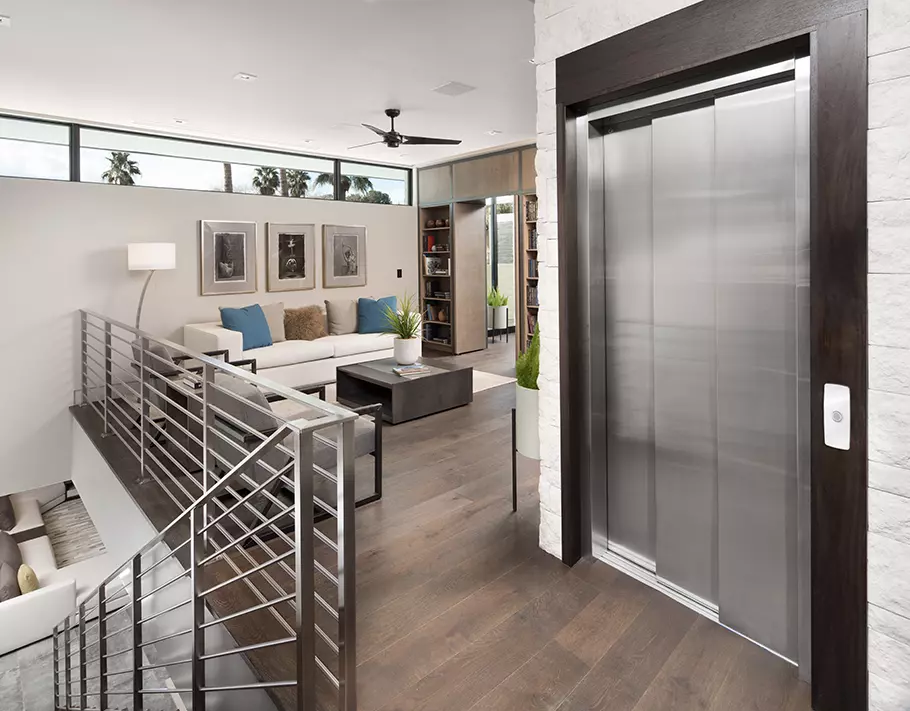 Home elevator with closed 3 speed sliding doors in a modern home