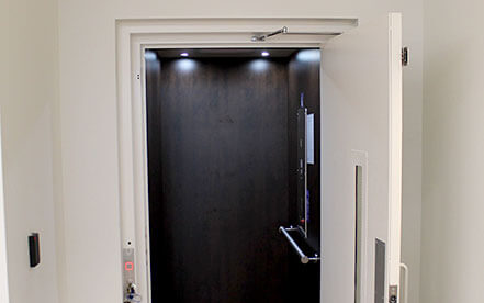 Home Elevator with open swinging hall doors used for accessibility needs