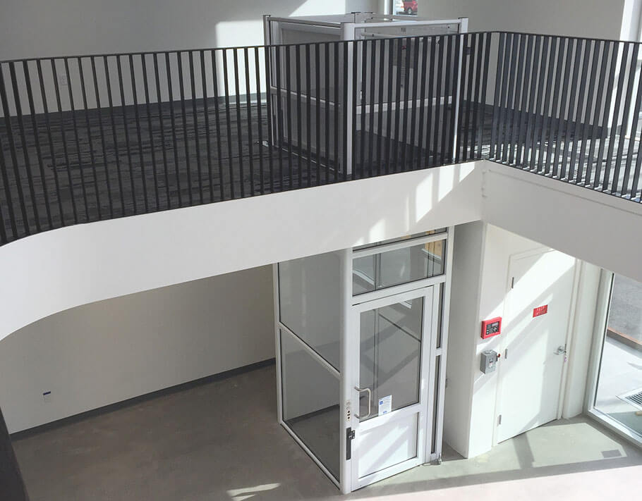 Genesis enclosure model vertical platform wheelchair lift with swinging hall door as seen from the top floo