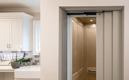 /Fixture inside home elevator with light hardwood walls