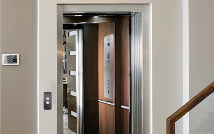 Home elevator with open swinging hall door