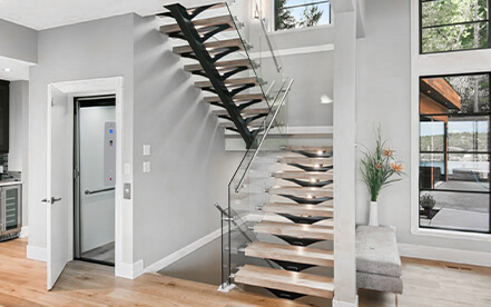 Close up of the home elevator fixture in hallway next to the open door