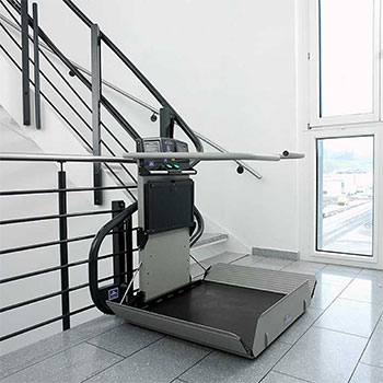 Garaventa Artira inclined platform lift installed on a stairway for wheelchair accessibility